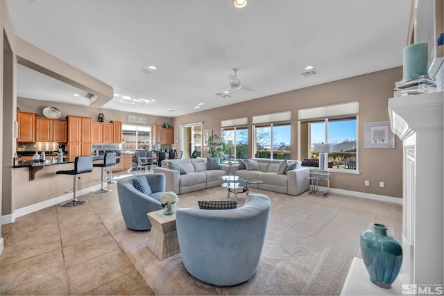 living area featuring baseboards, visible vents, ceiling fan, and recessed lighting