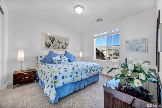 carpeted bedroom featuring visible vents and baseboards