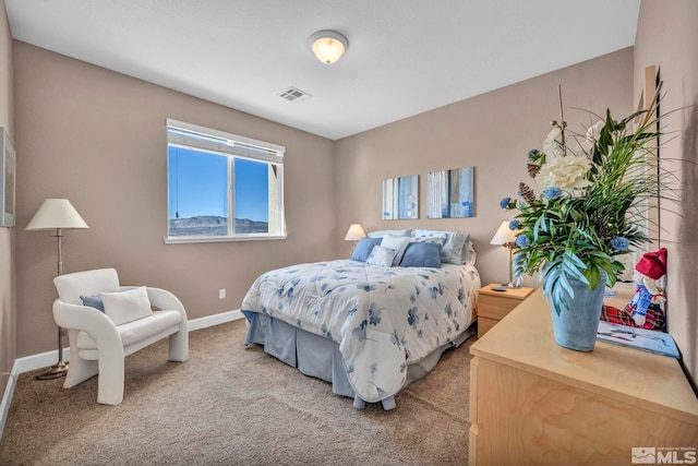 carpeted bedroom featuring visible vents and baseboards