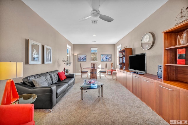 living room featuring a ceiling fan, carpet flooring, and visible vents