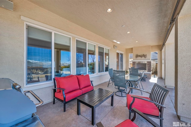 view of patio / terrace with outdoor dining area and exterior fireplace