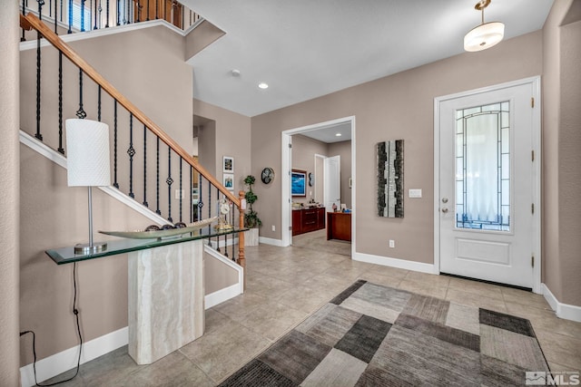 tiled entrance foyer with recessed lighting, stairway, and baseboards