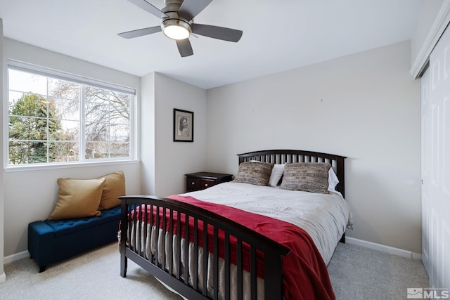 bedroom with carpet, a closet, ceiling fan, and baseboards