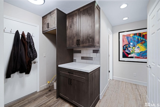 interior space featuring recessed lighting, light wood-style flooring, and baseboards