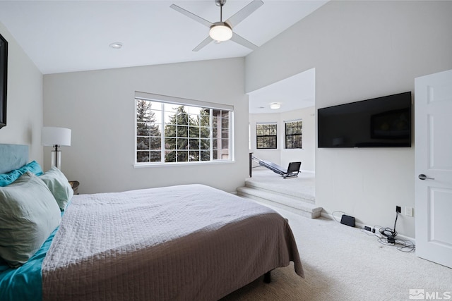 bedroom featuring carpet floors, lofted ceiling, and ceiling fan