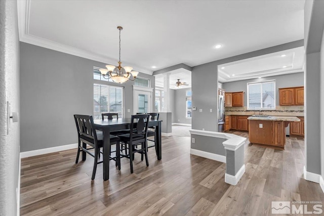 dining area with recessed lighting, light wood finished floors, baseboards, and ceiling fan with notable chandelier