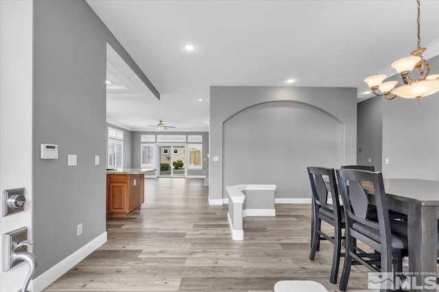 dining area featuring ceiling fan with notable chandelier, recessed lighting, baseboards, and light wood-style floors