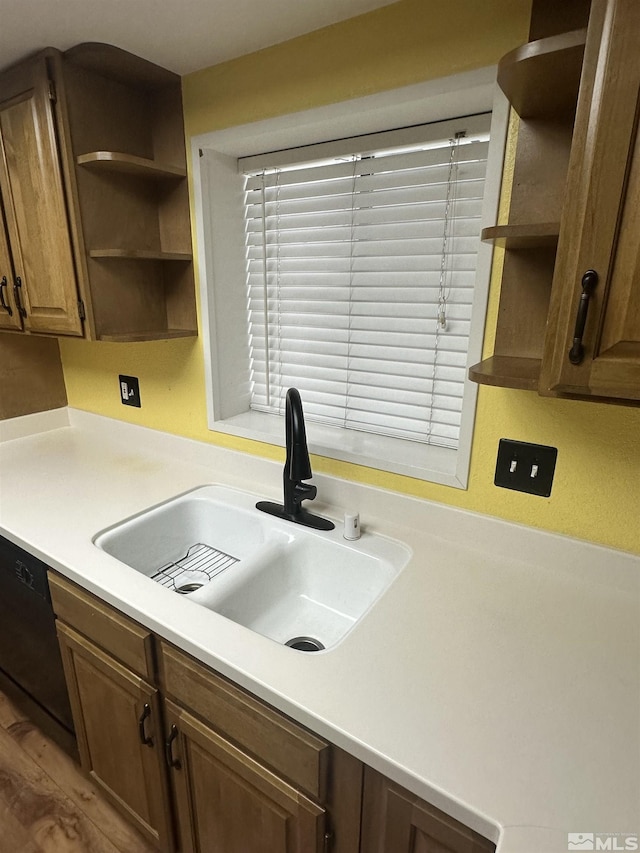 kitchen featuring light countertops, a sink, dishwasher, and open shelves