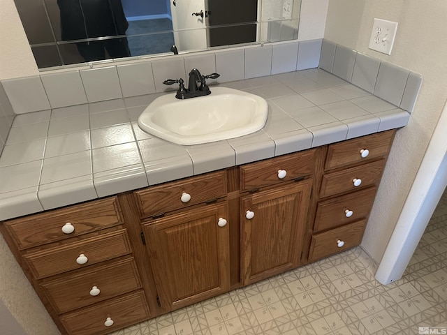 bathroom with decorative backsplash, vanity, and tile patterned floors