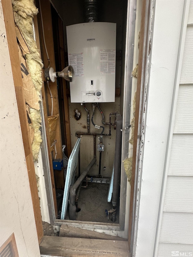 utility room with tankless water heater