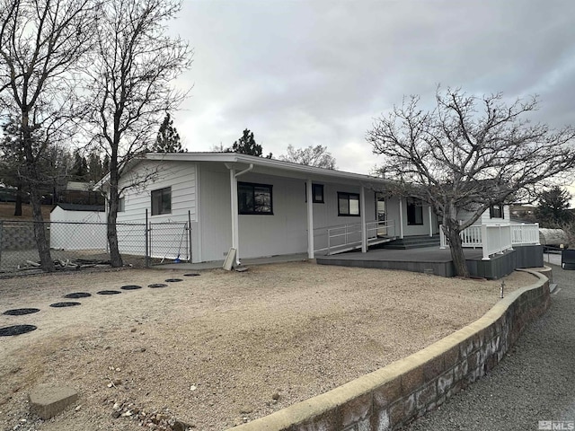 view of front of house featuring fence and a wooden deck