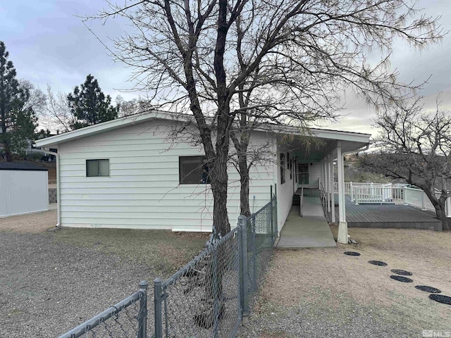 exterior space featuring fence and a porch