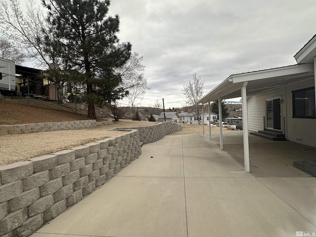 view of patio / terrace featuring entry steps and an attached carport