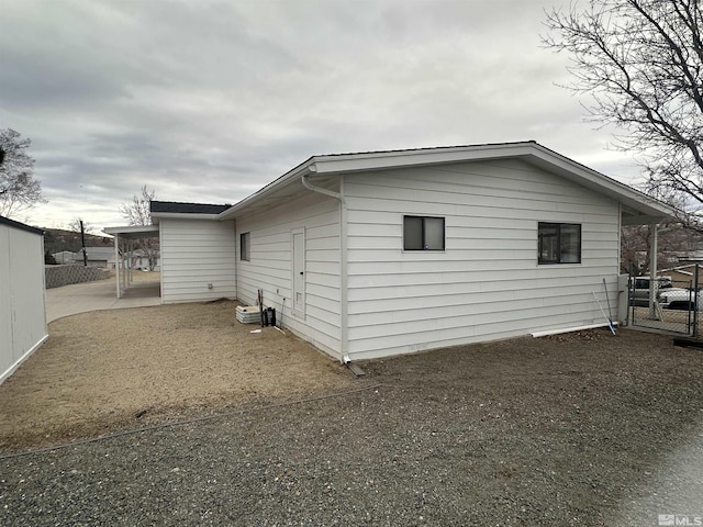 view of side of property featuring fence