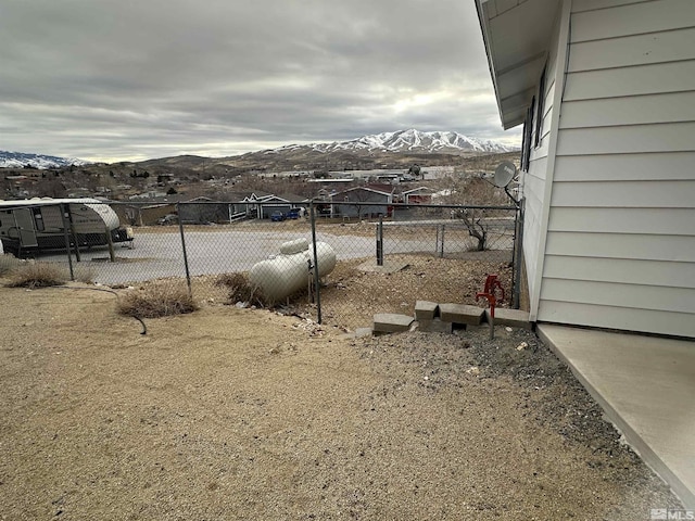 view of yard featuring fence and a mountain view