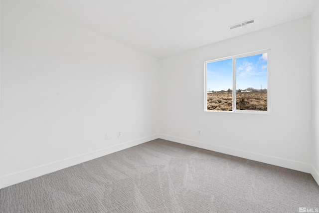 spare room featuring carpet floors, baseboards, and visible vents