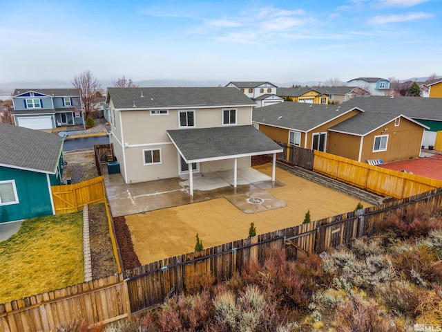 back of property featuring roof with shingles, a patio, a gate, a residential view, and a fenced backyard