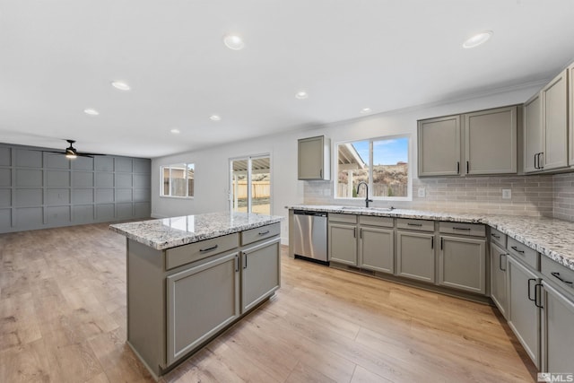 kitchen featuring a sink, gray cabinets, and stainless steel dishwasher