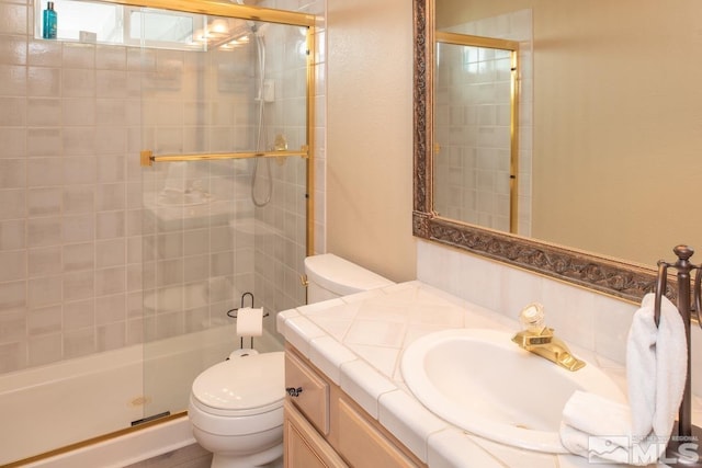 full bathroom featuring a stall shower, vanity, and toilet