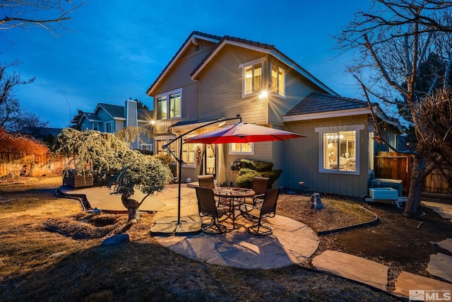 rear view of property featuring a patio area and fence