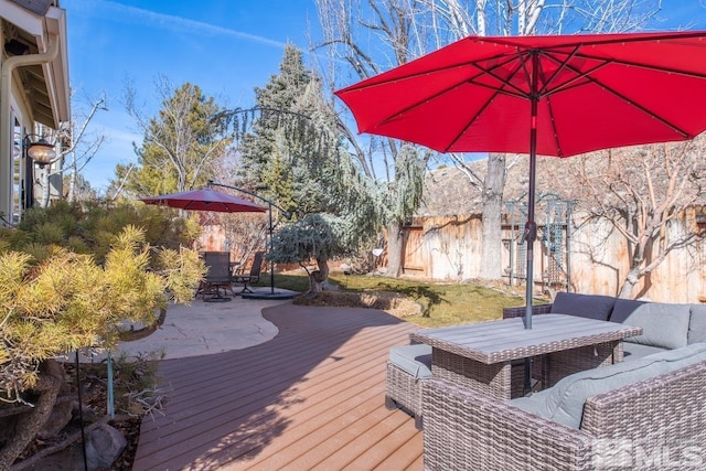 deck featuring outdoor dining area, outdoor lounge area, and fence