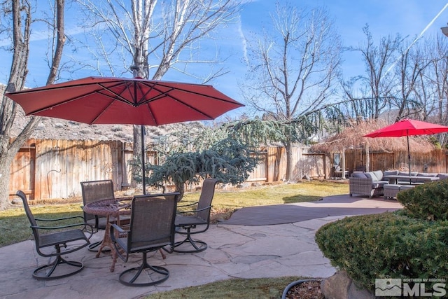 view of patio featuring an outdoor hangout area, outdoor dining space, and a fenced backyard