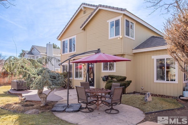 back of property with a patio area and fence