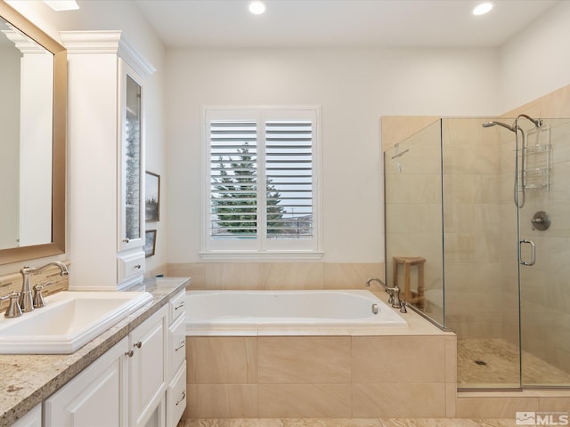 full bathroom featuring a stall shower, vanity, a bath, and recessed lighting