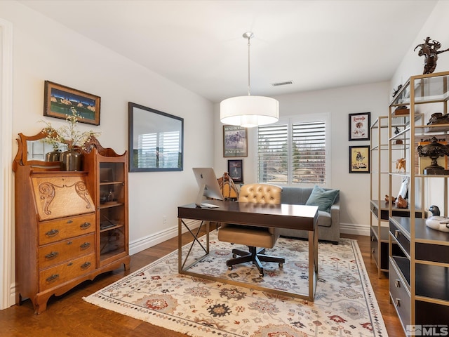 office with visible vents, dark wood finished floors, and baseboards