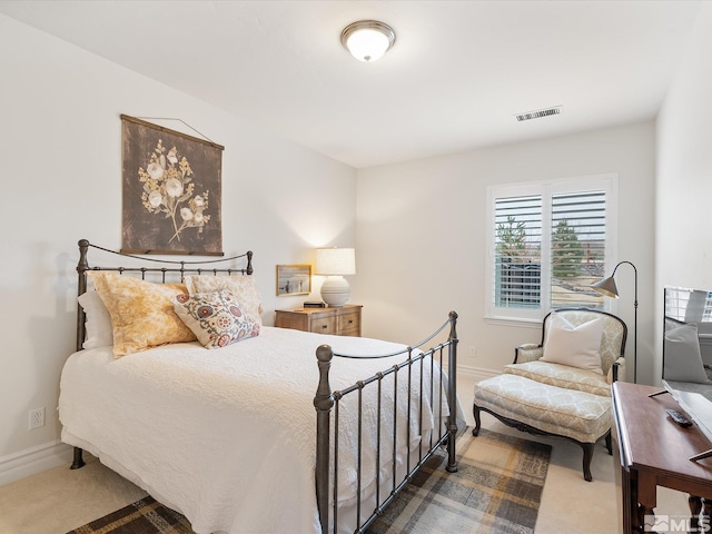 carpeted bedroom featuring visible vents and baseboards