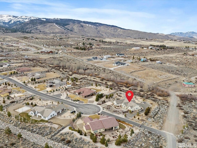 birds eye view of property featuring a mountain view