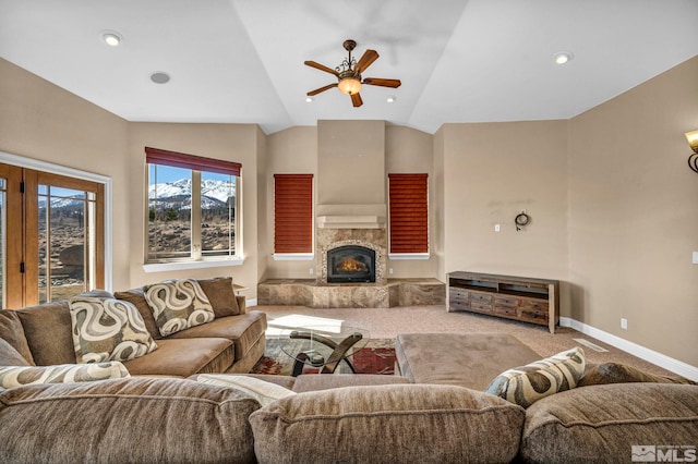 carpeted living area with a fireplace, lofted ceiling, recessed lighting, ceiling fan, and baseboards