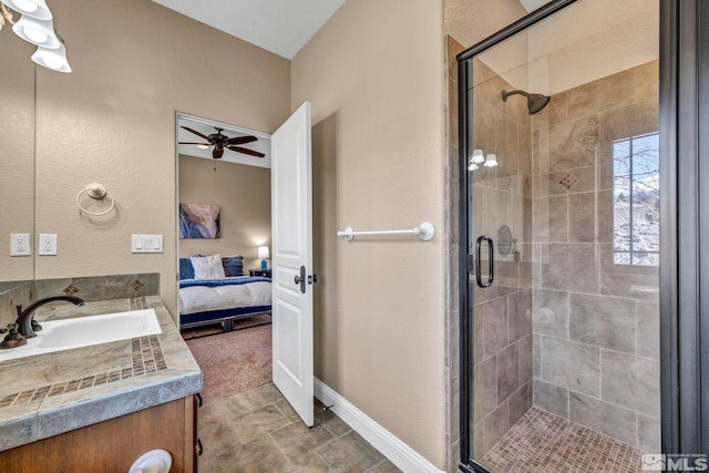 full bathroom featuring ceiling fan, connected bathroom, vanity, baseboards, and a shower stall