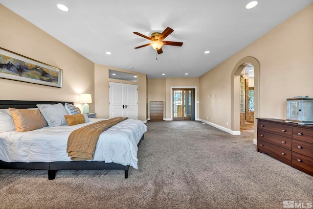 bedroom featuring baseboards, arched walkways, carpet flooring, and recessed lighting