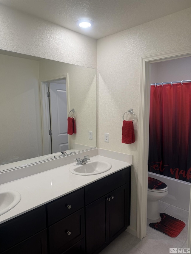 full bath featuring double vanity, shower / tub combo, toilet, tile patterned flooring, and a sink