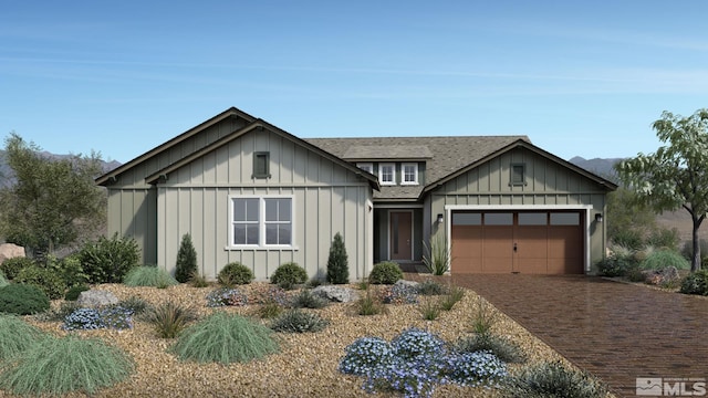 modern farmhouse featuring an attached garage, a shingled roof, decorative driveway, and board and batten siding