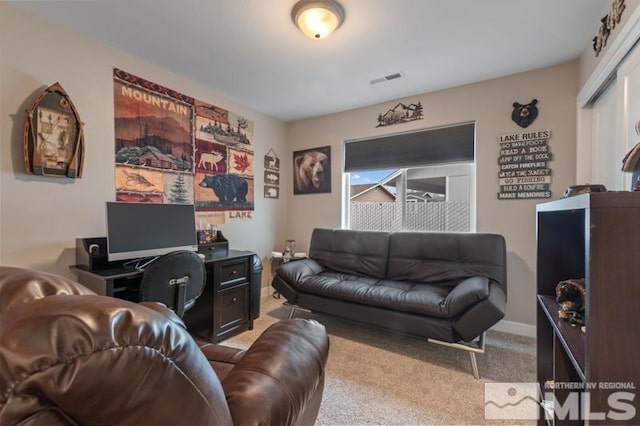 living area with visible vents, baseboards, and carpet flooring