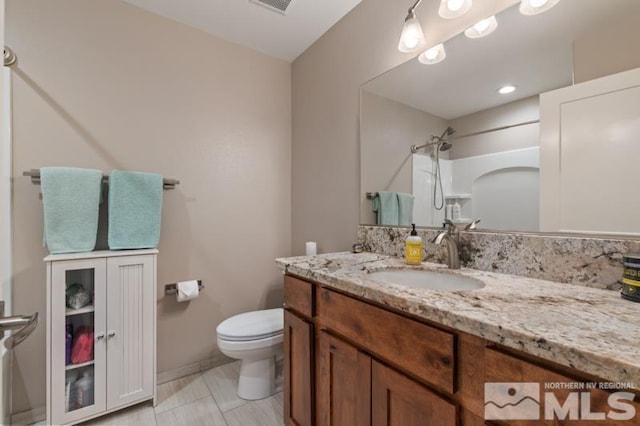 bathroom featuring visible vents, a shower, toilet, and vanity