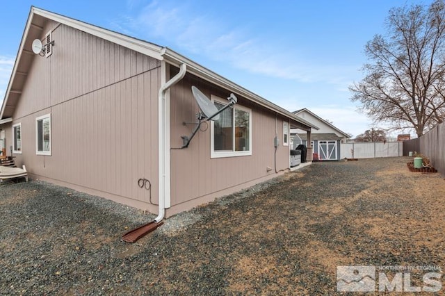 view of side of home with fence