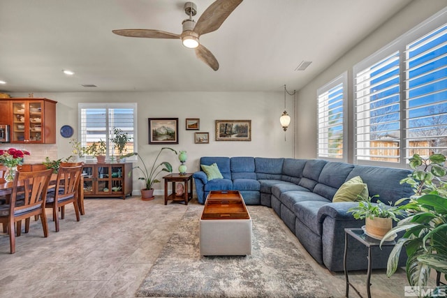 living area with baseboards, visible vents, a ceiling fan, and recessed lighting