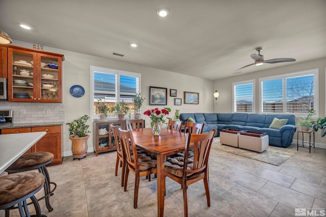 dining area featuring baseboards, a ceiling fan, visible vents, and recessed lighting