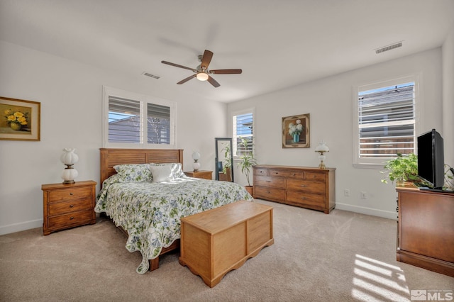 bedroom with baseboards, ceiling fan, visible vents, and light colored carpet