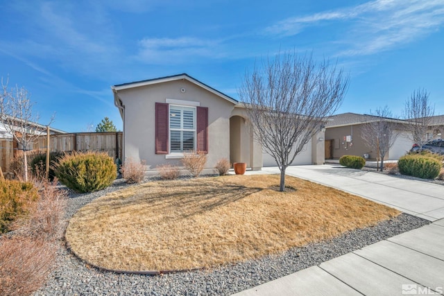 single story home with a garage, concrete driveway, fence, and stucco siding