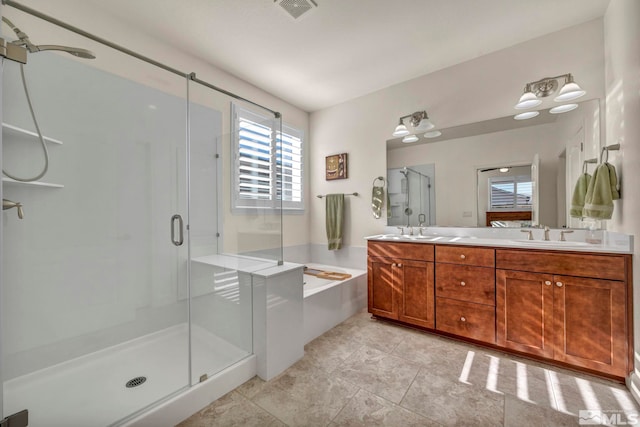 full bathroom featuring a bath, a stall shower, a sink, and visible vents