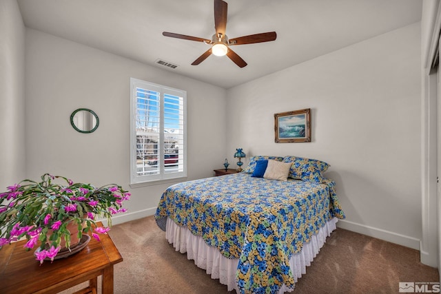 carpeted bedroom featuring a ceiling fan, visible vents, and baseboards