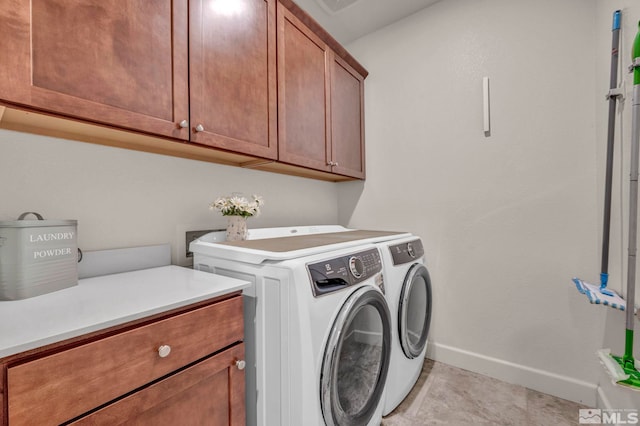 washroom featuring cabinet space, independent washer and dryer, baseboards, and light tile patterned floors