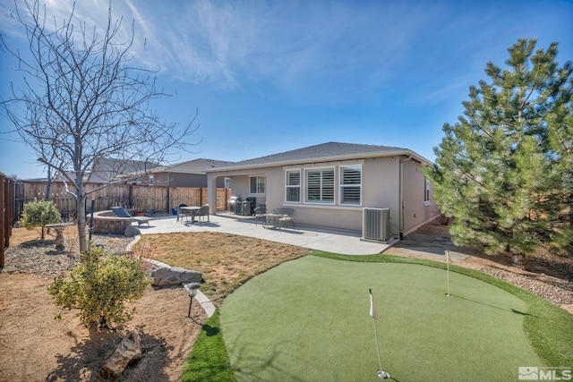 back of property featuring central AC, a patio area, a fenced backyard, and stucco siding