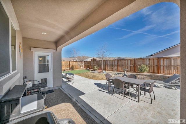 view of patio / terrace featuring outdoor dining area and a fenced backyard