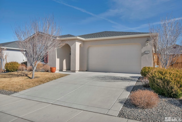 ranch-style house with a garage, a shingled roof, concrete driveway, and stucco siding