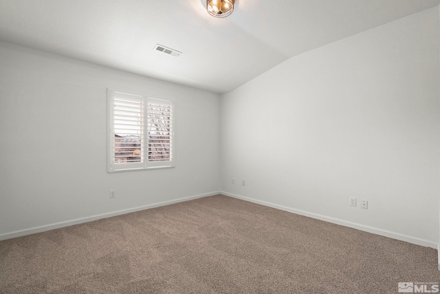 carpeted spare room featuring vaulted ceiling, visible vents, and baseboards